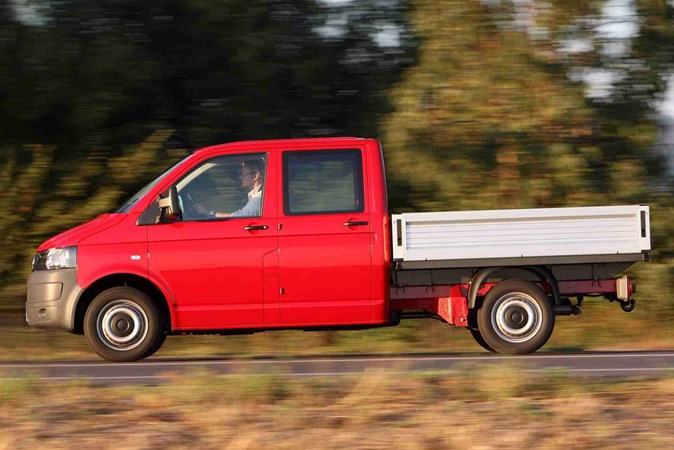 Image of the Volkswagen T5.1 double-can pickup truck, in red, viewed from the left side