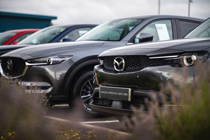 Line-up of Mazda cars on a dealer forecourt