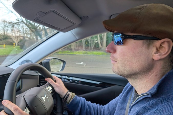 Image of a man driving while wearing curved, polarised sunglasses