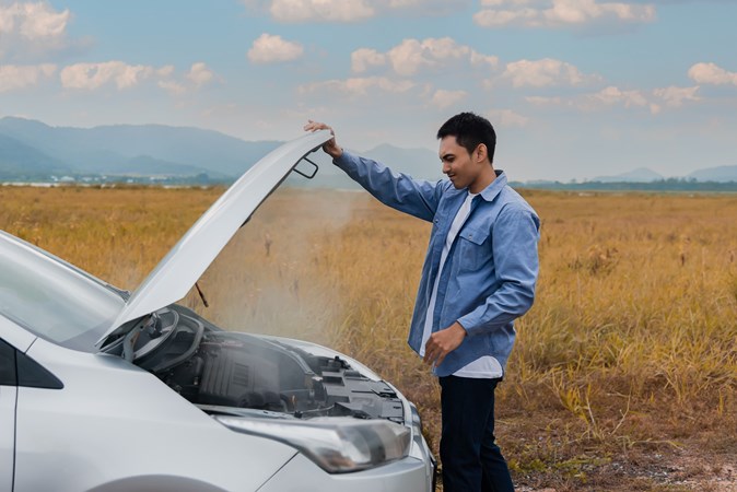 Image of a man lifting the bonnet of an overheating Ford Fiesta