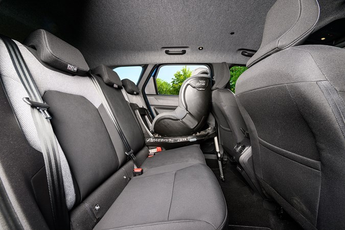 Dacia Bigster (2025) review: rear seat with child seat, black and grey upholstery