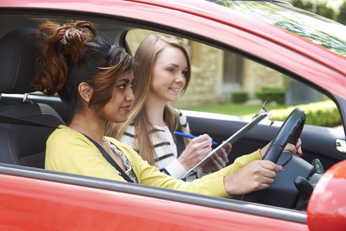 Image of a young female driving student under instruction