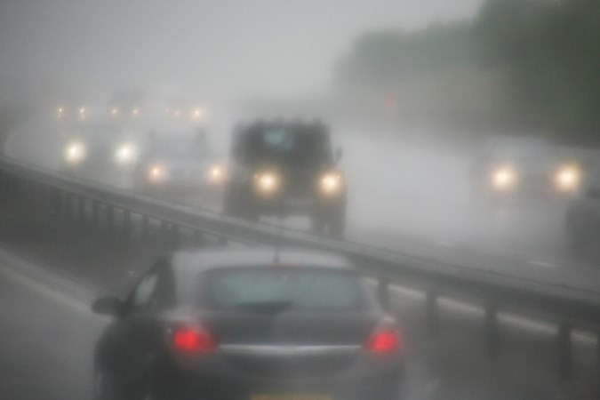 Image of heavy traffic on a foggy motorway