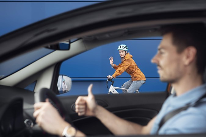 Image of a driver giving a cyclist the thumbs up while passing safely