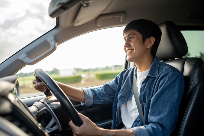 Image of a young man driving solo