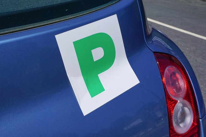 Close-up image of a green P plate on the back of a Nissan Micra