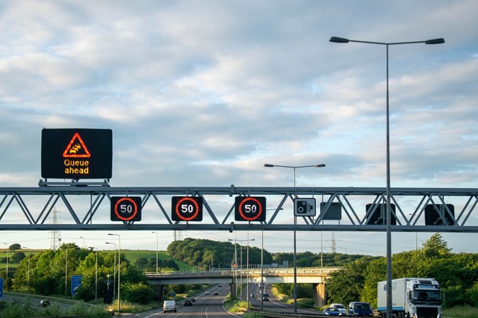 Image of a UK motorway overhead gantry showing a 50mph speed limit