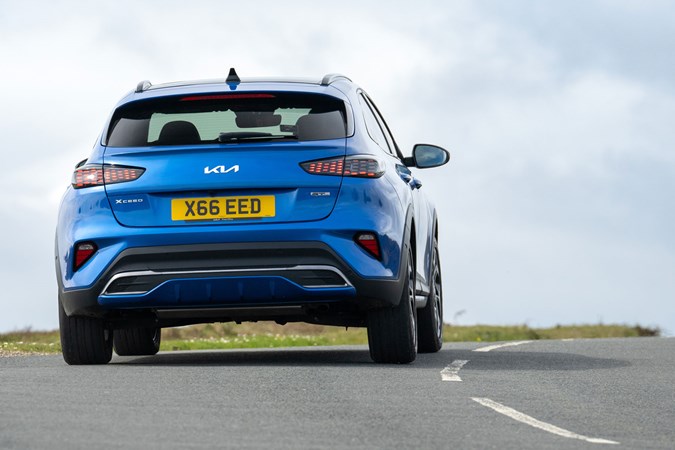 Kia XCeed review - facelift, blue, rear, driving round corner