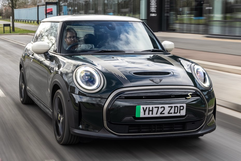 MINI Electric driving on an urban street. Front 3/4.