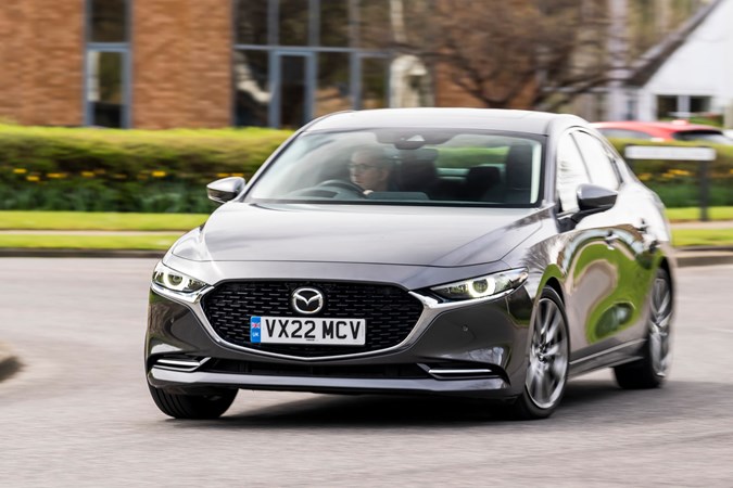 Mazda 3 Saloon review, front, grey, driving round roundabout