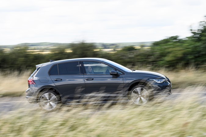 Volkswagen Golf (2024) review: side view pan shot, grey paint