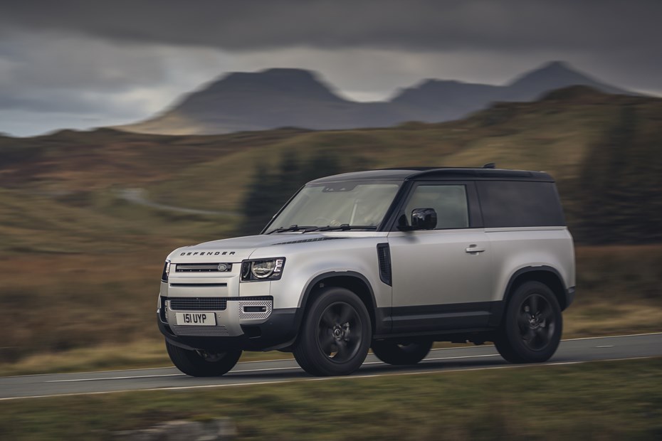 Silver 2021 Land Rover Defender 90 driving front three-quarter