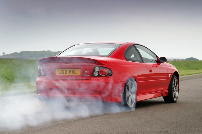 Vauxhall Monaro, red, rear three quarters, tyre smoke | Parkers WCPGW