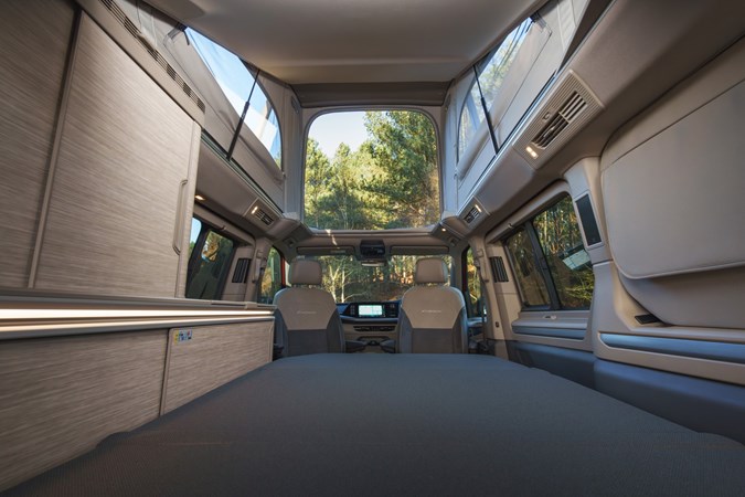 Image of the Volkswagen California interior with bed folded out and pop top raised