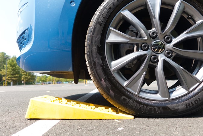 Image of levelling wedges under the front wheel of a Volkswagen California