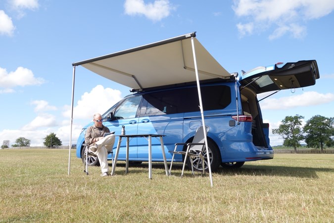 Image of a Volkswagen California set up with outdoor furniture