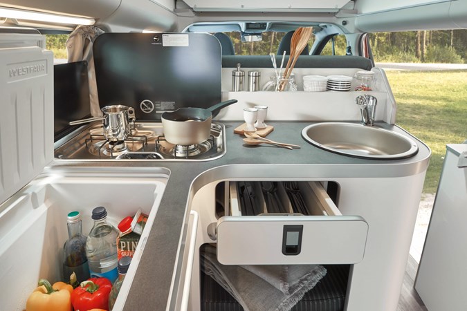 Image of a Ford Nugget kitchen with kitchenware out
