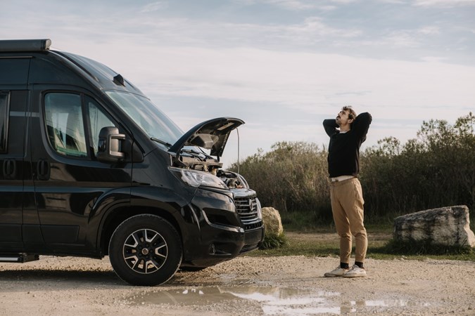 Image of a man with a broken down campervan