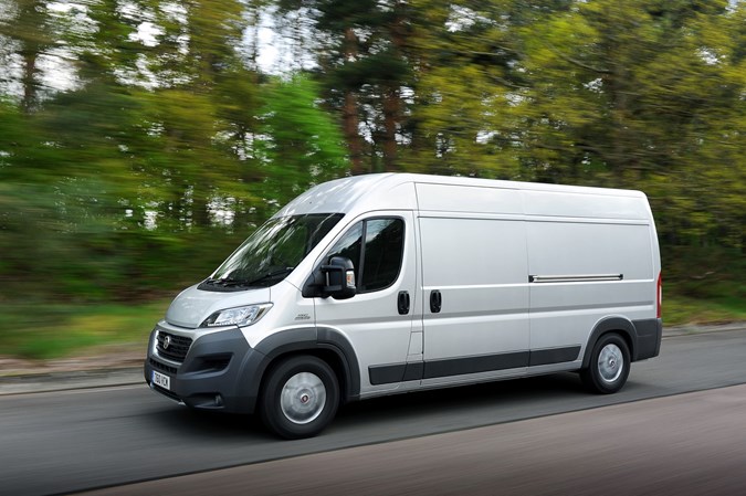 Image of a silver Fiat Ducato driving on a country road, viewed from the left side