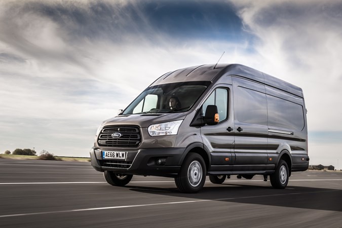 Image of a grey Ford Transit driving, viewed from the front left corner