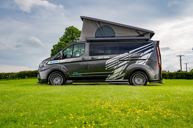 Image of a Ford Transit Custom MS-RT Wellhouse campervan, with roof raised, viewed from the left side
