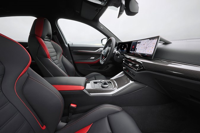 BMW i4 (2024) review: front seats and dashboard, black and red leather upholstery