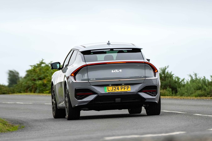 Kia EV6 review: rear three quarter cornering, grey paint, country road