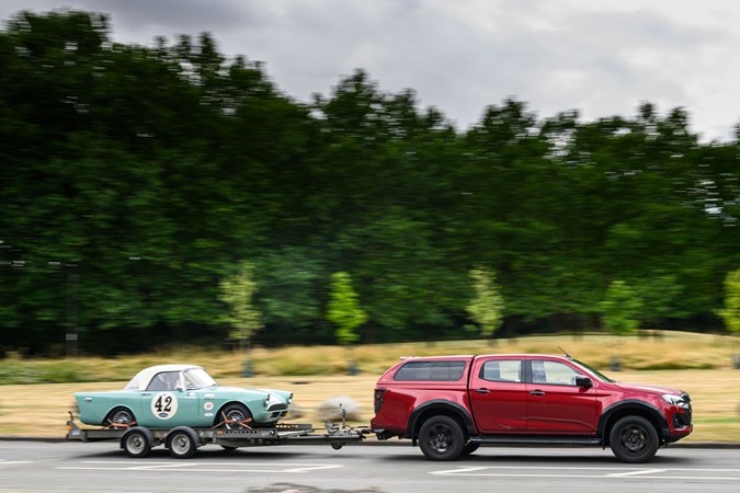Isuzu D-Max V-Cross towing a trailer with a racing car loaded on it