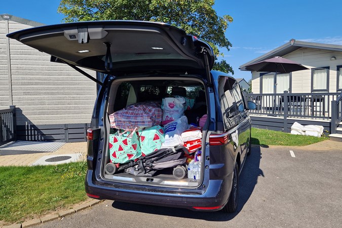 VW Multivan review, blue eHybrid, boot space filled with pushchair and other holiday luggage, showing huge tailgate, Bauer exclusive image