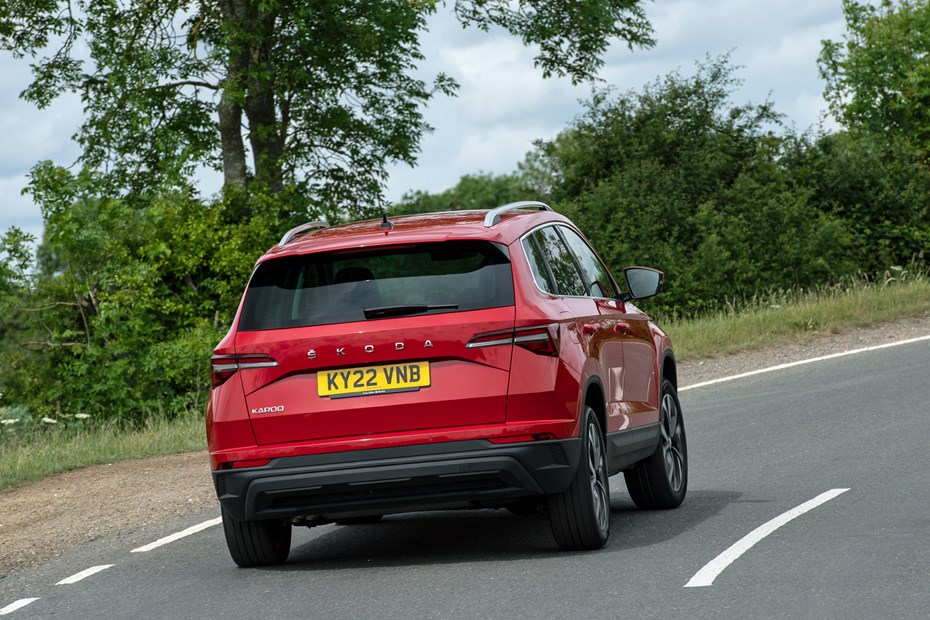 Skoda Karoq review, SE L, red, rear view, driving round corner