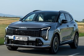 Kia Sportage review, silver, moving, front three quarters (2025)
