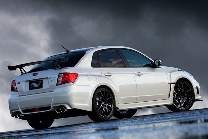 Studio image of a white Subaru WRX S206, viewed from the rear right corner