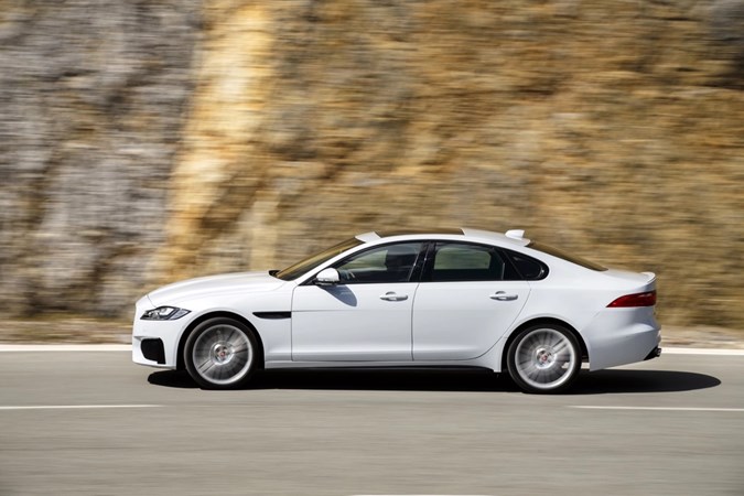 Image of a white Jaguar XF, viewed from the left side while driving