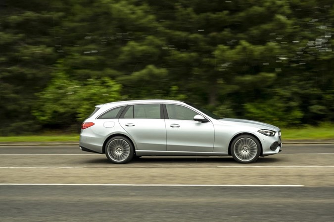 Image of a silver Mercedes C-Class estate, viewed from the right side while driving