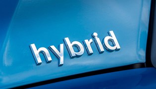 Close up image of the 'Hybrid' badge on a Toyota Prius