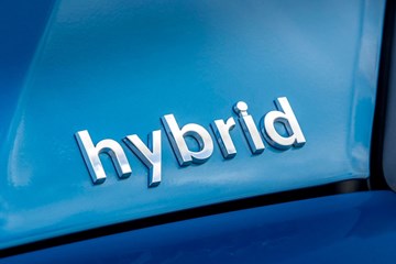 Close up image of the 'Hybrid' badge on a Toyota Prius