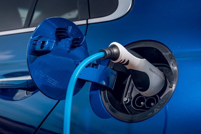 Close-up image of an EV charging cable plugged into a car