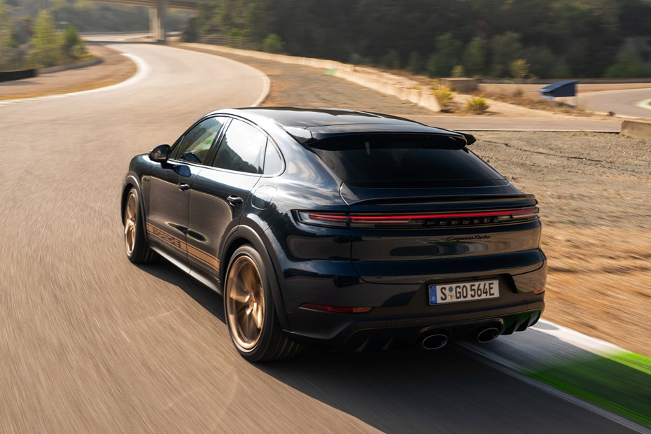 Porsche Cayenne Coupe review - 2023 facelift - Turbo E-Hybrid with GT Package, rear, blue and gold, driving round corner on racing circuit