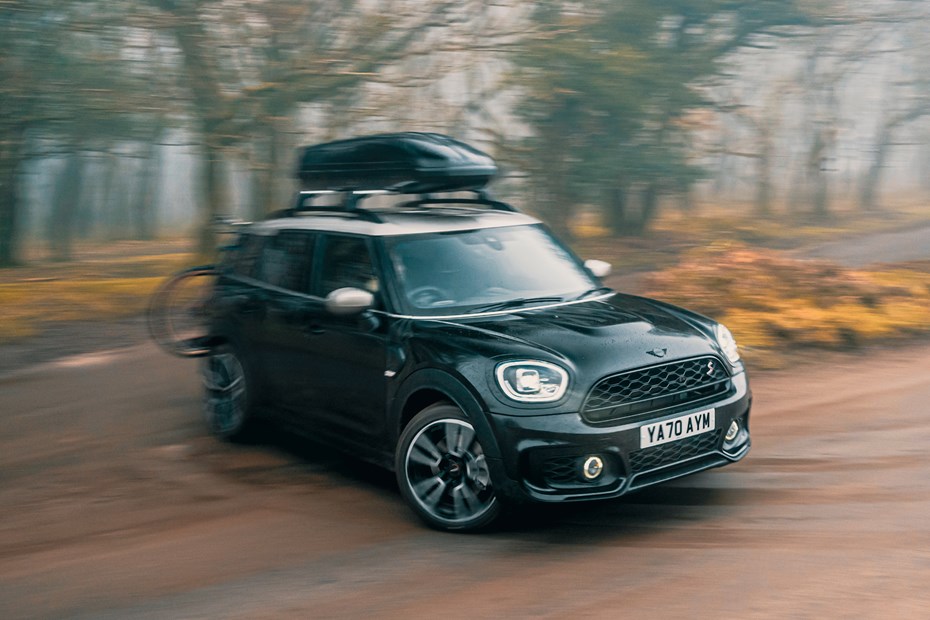 MINI Countryman (2023) review: front three quarter cornering, moving from gravel to tarmac road, black paint
