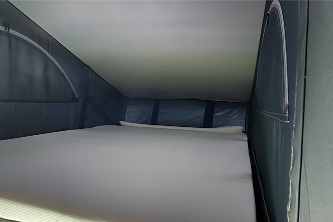 The sleeping area of the VW California with the roof popped