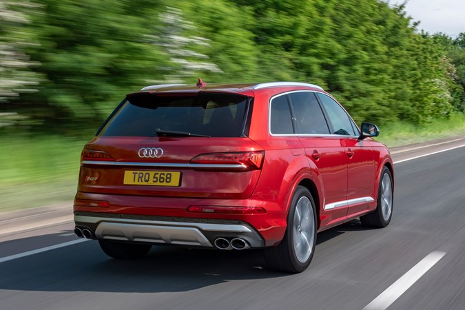 Audi SQ7 review (2022) - rear three quarter rolling shot, red car, leafy road