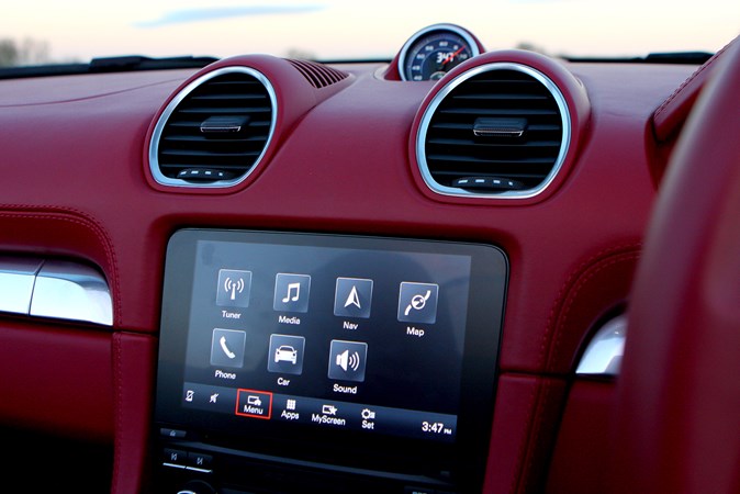 Porsche 718 Boxster, infotainment screen and climate controls, red leather upholstery