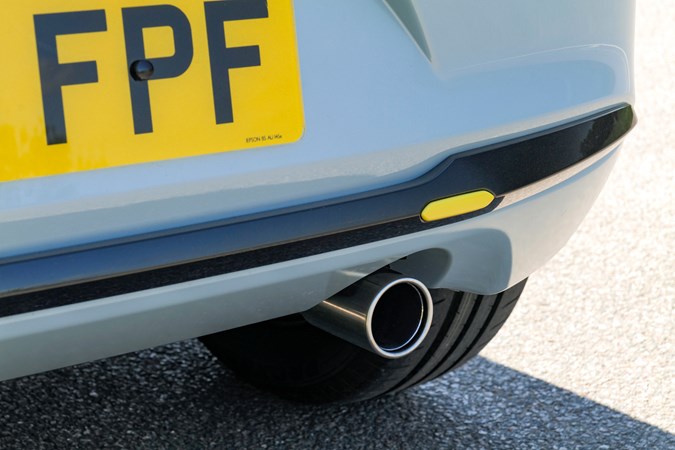 Mazda 2 (2023) review: exhaust detail, showing yellow accent on bumper, blue paint
