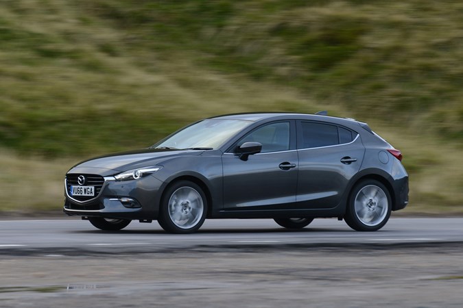 Mazda 3 in gunmetal driving shot